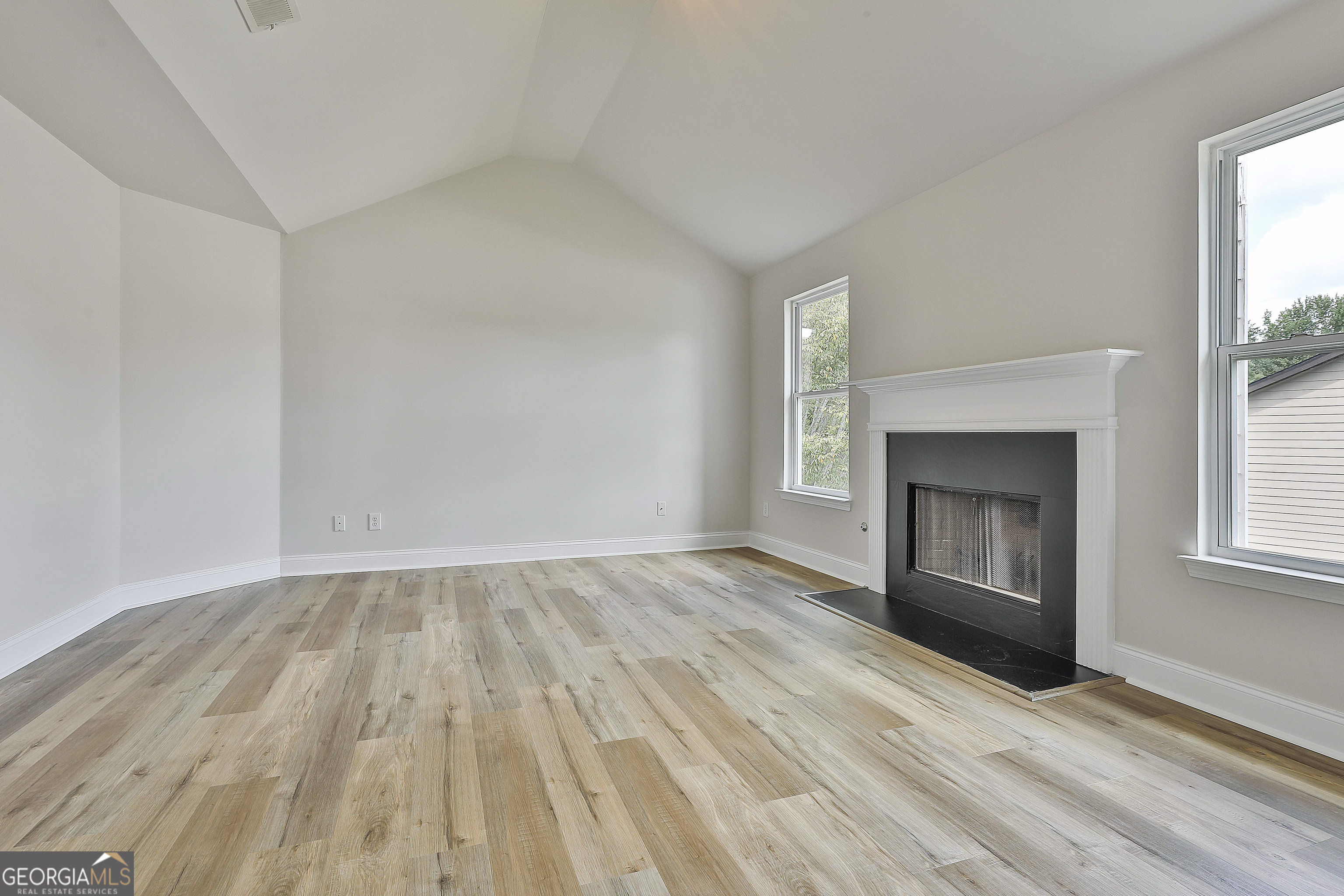 28 Fox Ridge Drive Newnan, GA 30265 - Photo 27 of 48 wooden floor fireplace and windows in an empty room