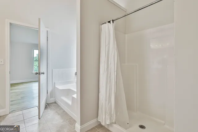 a bathroom with a shower and a sink