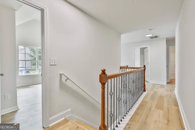 a view of a hallway with windows and stairs