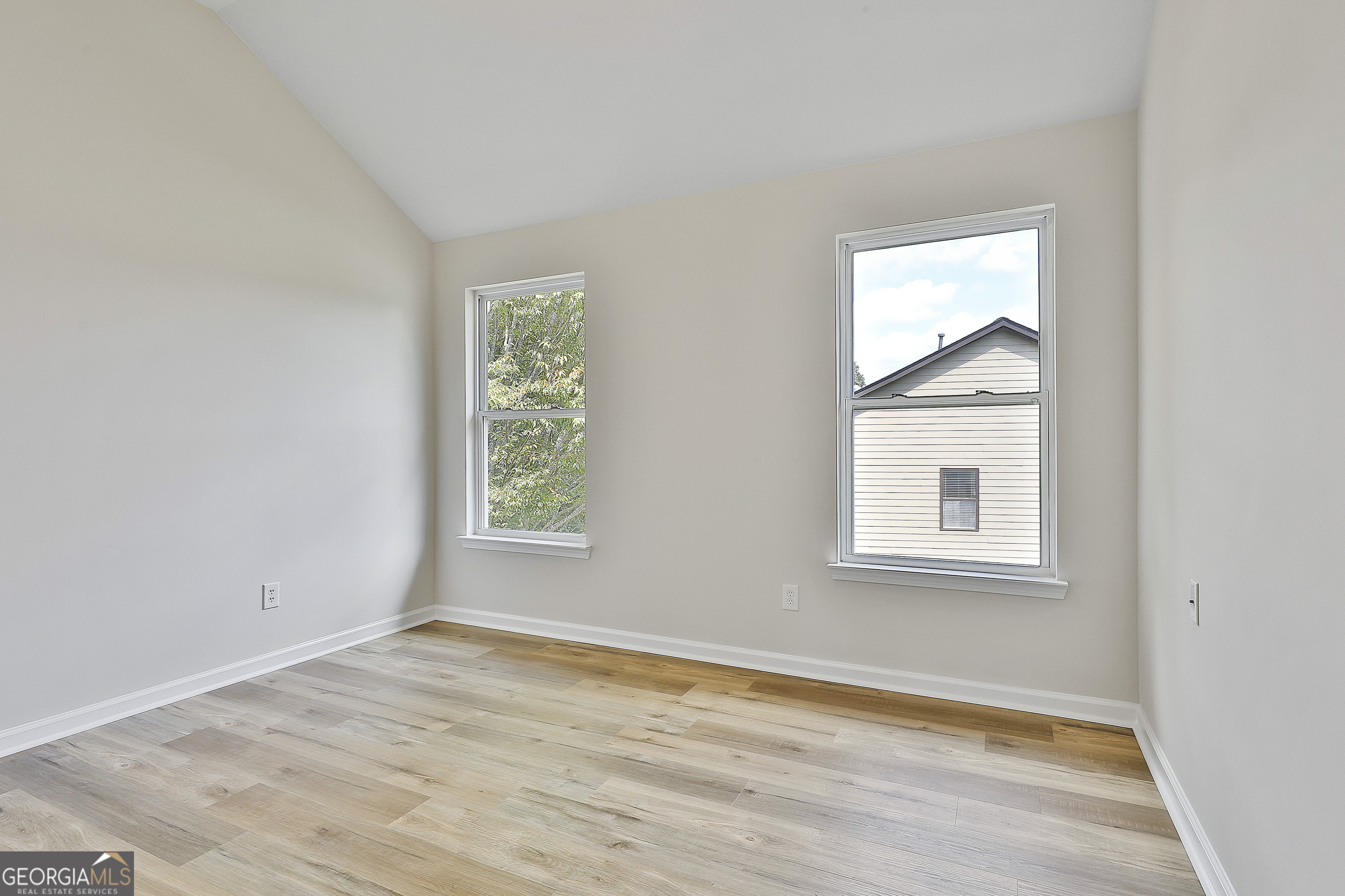 28 Fox Ridge Drive Newnan, GA 30265 - Photo 36 of 48 an empty room with wooden floor and windows