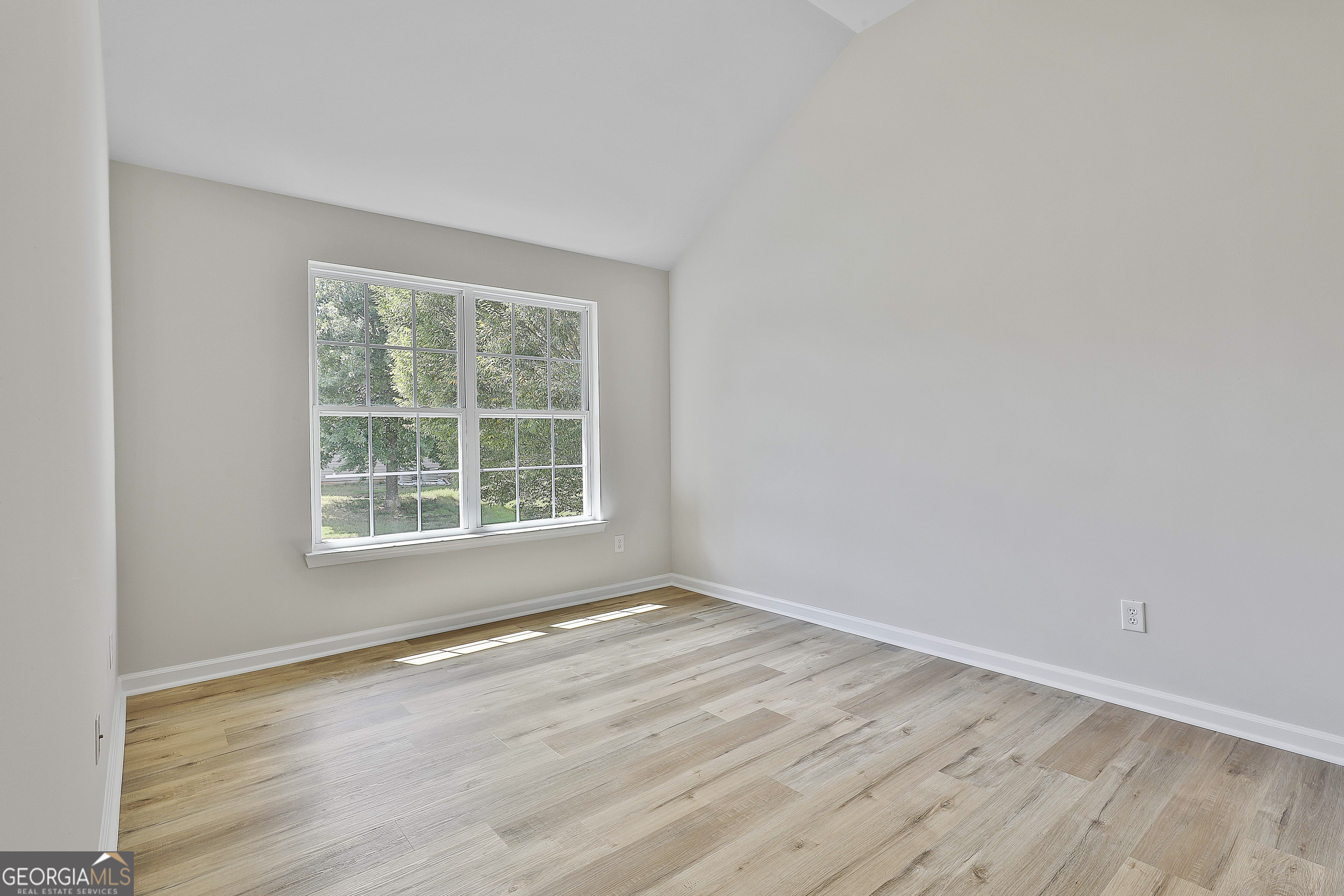 28 Fox Ridge Drive Newnan, GA 30265 - Photo 38 of 48 a view of an empty room with wooden floor and a window