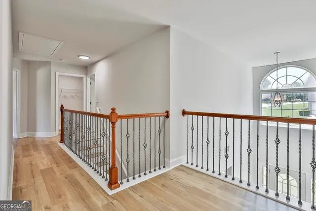 a view of a hallway with wooden floor