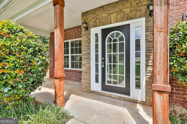 a front view of a house with outdoor space and garden