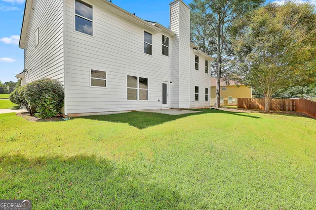 a house view with swimming pool in front of it
