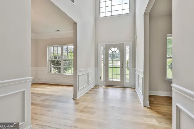 a view of an empty room with glass door and a window