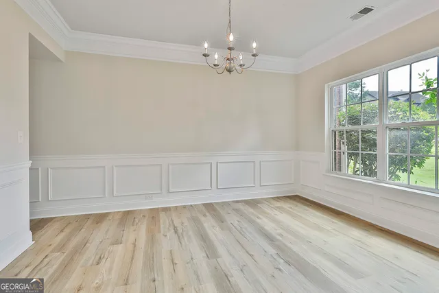 a view of wooden floor and windows in a room