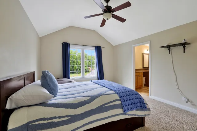 a bedroom with a bed dresser and a window