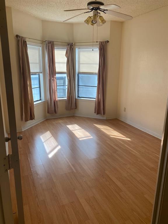 915 West 23rd Street, Unit 108 Austin, TX 78705 - Photo 8 of 14 an empty room with wooden floor and windows