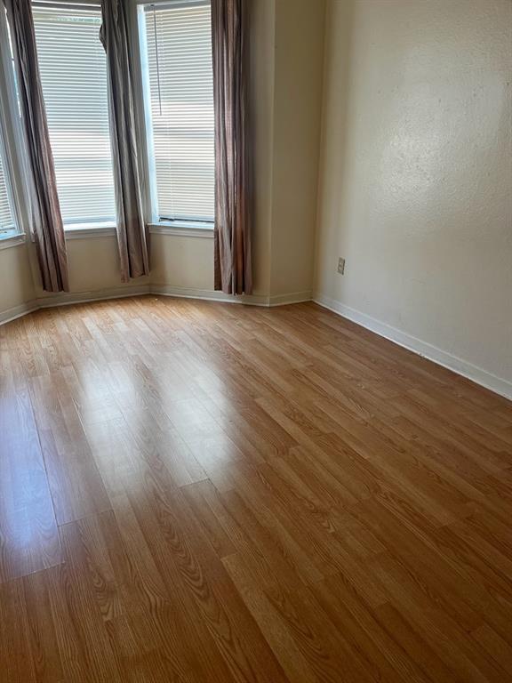 915 West 23rd Street, Unit 108 Austin, TX 78705 - Photo 9 of 14 a view of a livingroom with wooden floor and a window