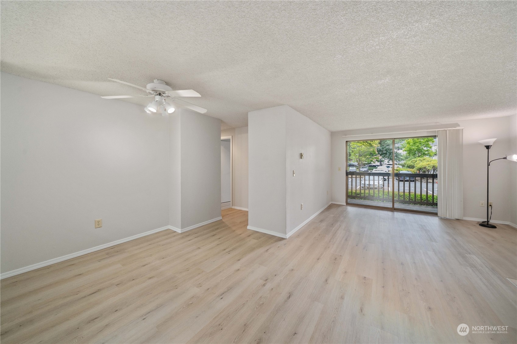 701 Southwest 5th Court, Unit B204 Renton, WA 98057 - Photo 6 of 18 a view of an empty room with wooden floor and a window