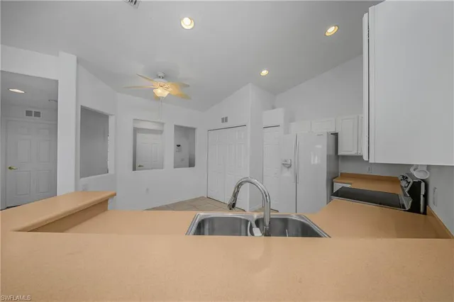 a kitchen with a sink and a refrigerator