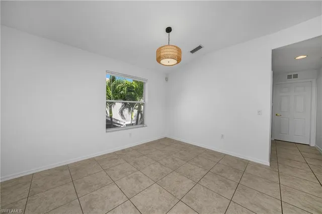 an empty room with windows and entrance