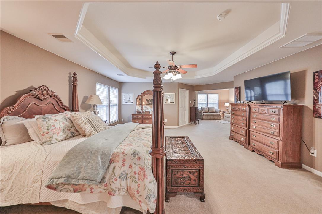 138 Clover Hollow Road Easton, PA 18045 - Photo 44 of 95 A spacious sleeping area with layered tray ceilings and soft carpet, providing a comfortable retreat.