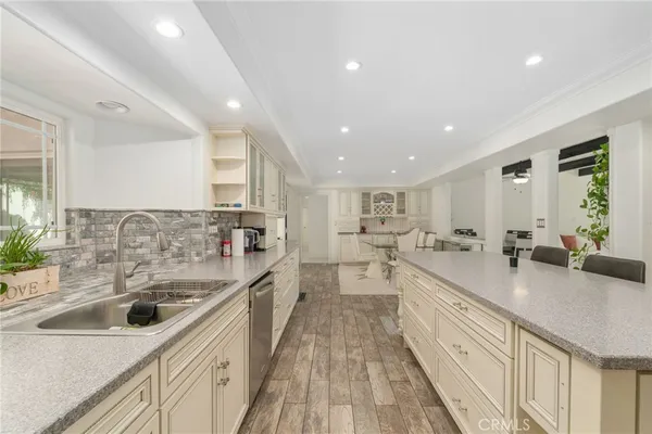 a kitchen with sink stove and refrigerator