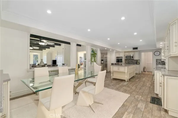 a living room with furniture a rug and kitchen view