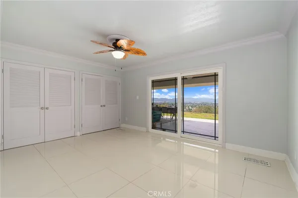 an empty room with windows and cabinet