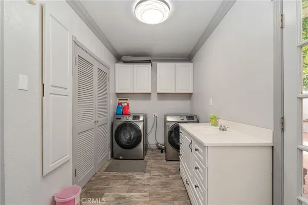 a utility room with sink dryer and washer