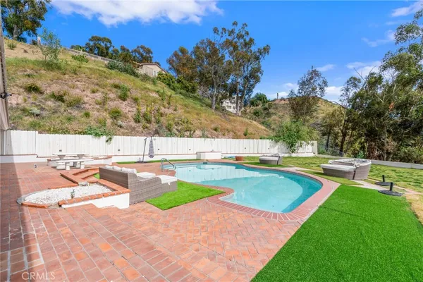 a view of a swimming pool with a yard