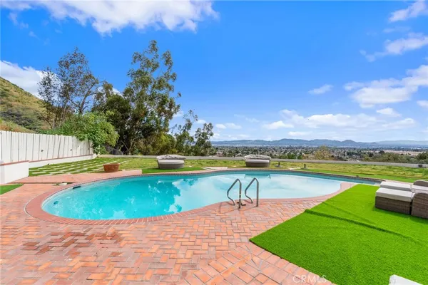 a view of a swimming pool with lounge chair