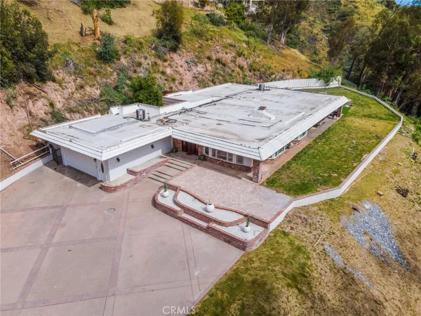 an aerial view of a house with a yard and balcony