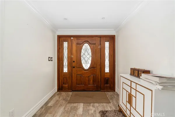 a view of an entryway with wooden floor