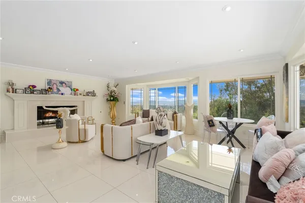 a living room with furniture and a floor to ceiling window