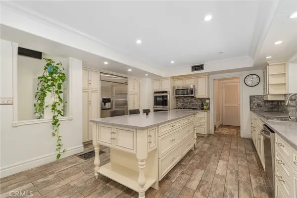 a kitchen with stainless steel appliances granite countertop a stove and a refrigerator
