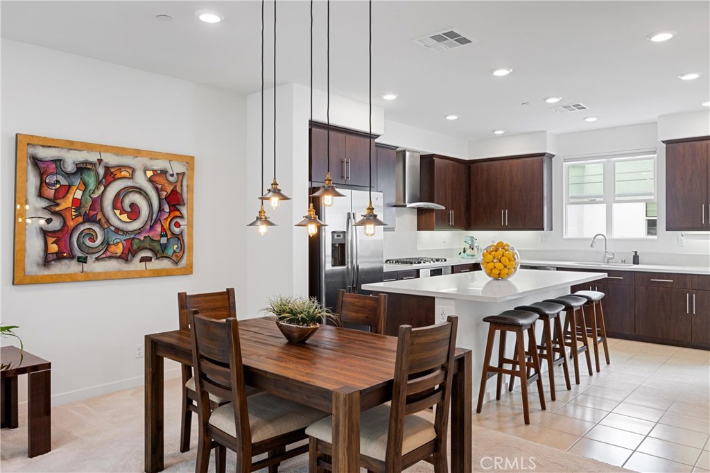 138 Acamar Irvine, CA 92618 - Photo 7 of 35 a kitchen with a dining table cabinets appliances and a center island