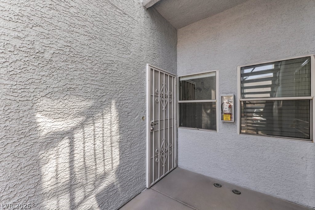 2201 Ramsgate Drive, Unit 1017 Henderson, NV 89074 - Photo 4 of 30 This entry features a security screen door and windows, offering peace of mind.