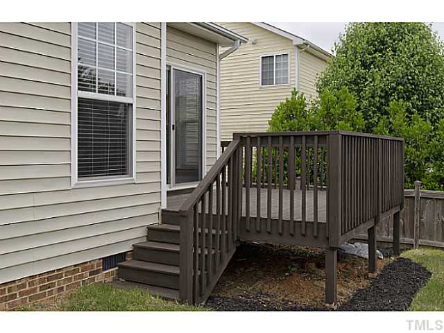 10624 Longholme Way Raleigh, NC 27614 - Photo 12 of 12 Sliding doors to the deck lead to the manicured backyard. Full grown trees allow for privacy and shade.