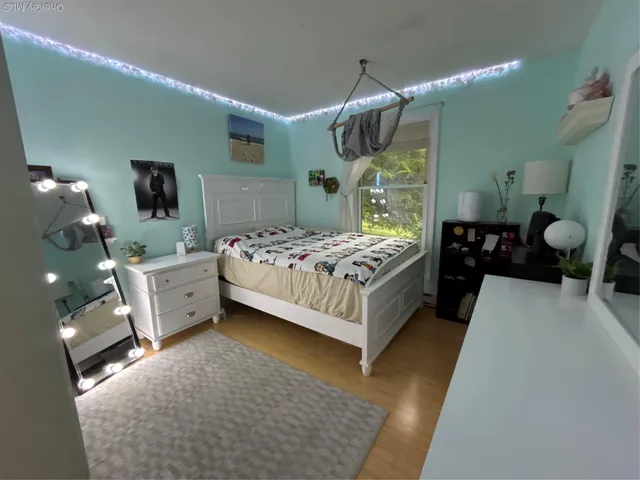 a bedroom with a bed and a mirror