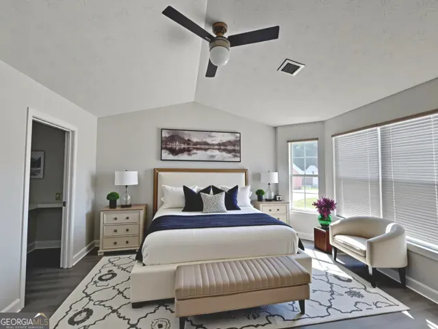 a bedroom with a large bed and a couch