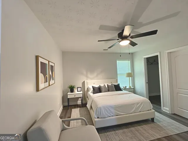 a bedroom with a large bed and a chandelier