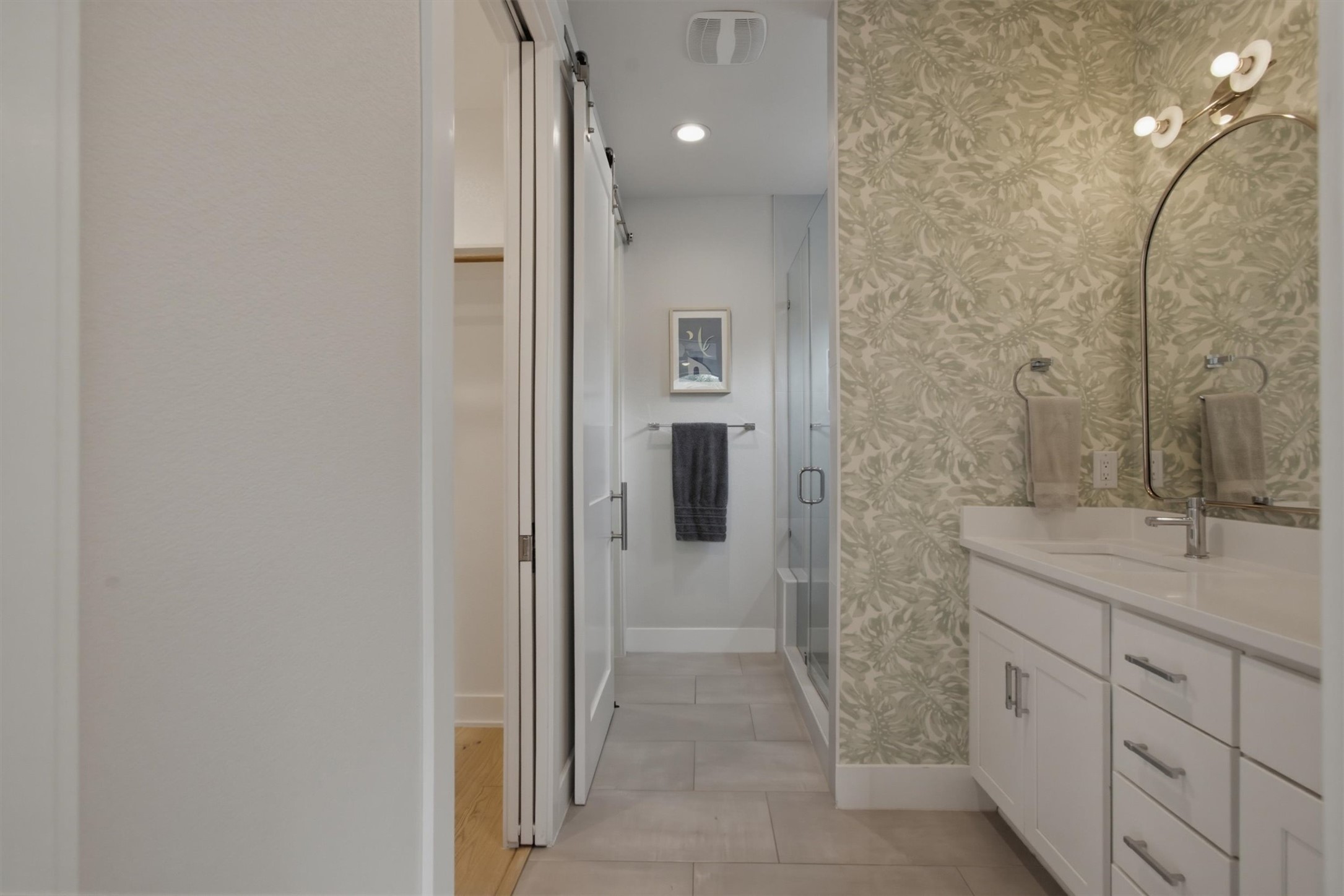 2710 Zaragosa Street, Unit A Austin, TX 78702 - Photo 16 of 29 Designer bath with dual-vanity, quartz counters, and a hallway leading to the bedroom suite.
