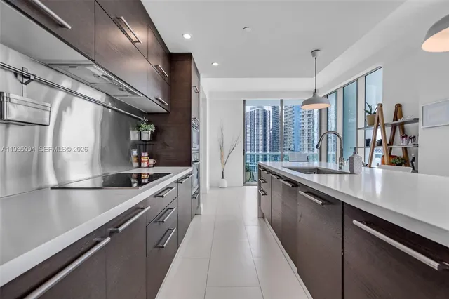 a view of a kitchen with dining table and chairs