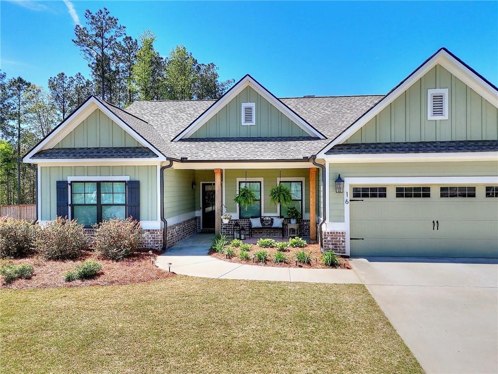 16 Boxwood Court Monroe, GA 30655 - Photo 2 of 41 a front view of a house with porch and garden