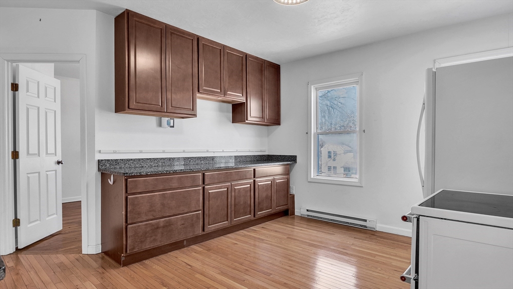 1442 Main Street, Unit 2 Worcester, MA 01603 - Photo 12 of 30 a kitchen with stainless steel appliances granite countertop a stove a sink and a refrigerator