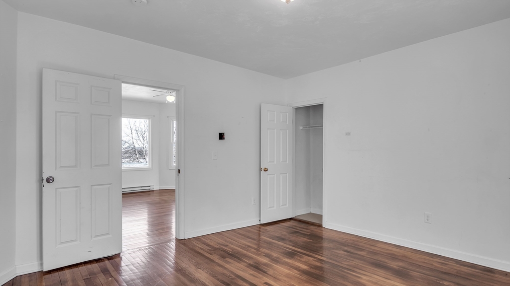 1442 Main Street, Unit 2 Worcester, MA 01603 - Photo 27 of 30 an empty room with wooden floor & windows