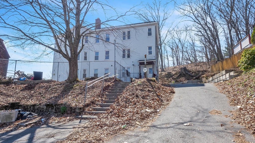 1442 Main Street, Unit 2 Worcester, MA 01603 - Photo 3 of 30 a view of a white house with a snow on the road
