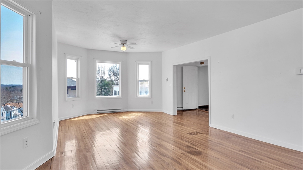 1442 Main Street, Unit 2 Worcester, MA 01603 - Photo 5 of 30 a view of an empty room with window and wooden floor