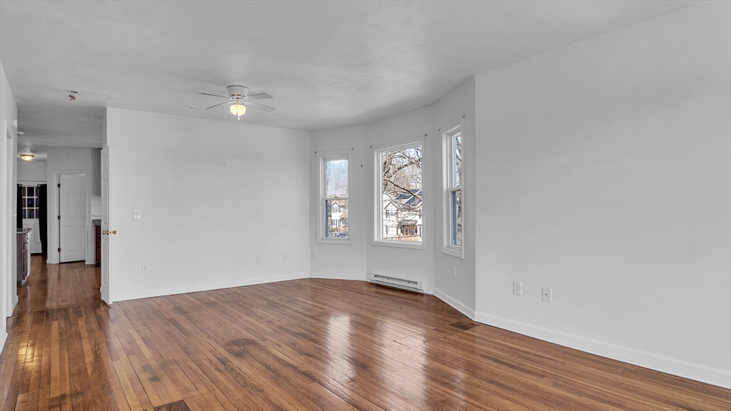 1442 Main Street, Unit 2 Worcester, MA 01603 - Photo 7 of 30 wooden floor in an empty room with a window