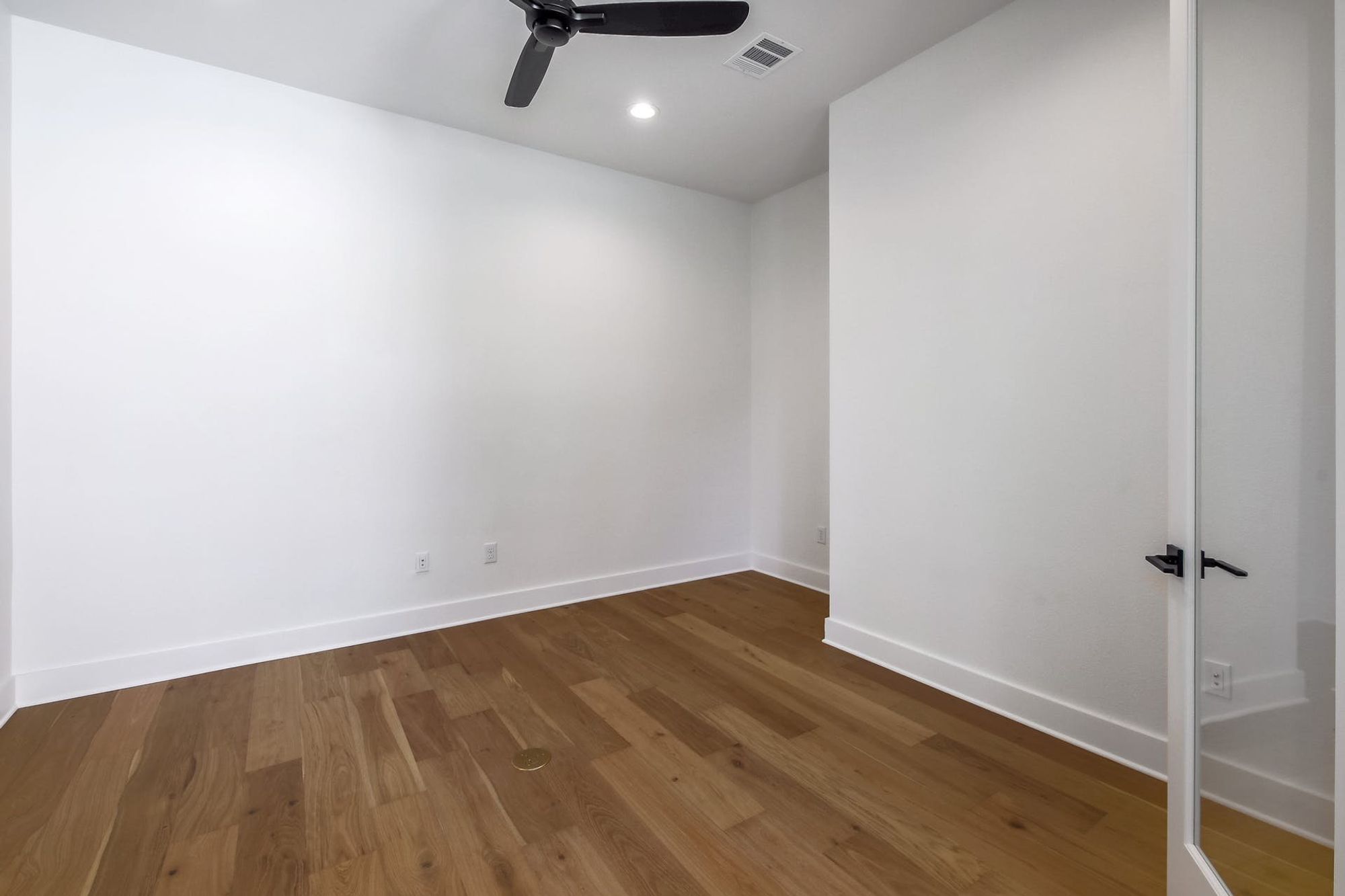 8302 Kromer Street Austin, TX 78757 - Photo 10 of 34 Empty room featuring dark wood-style floors, ceiling fan, and recessed lighting