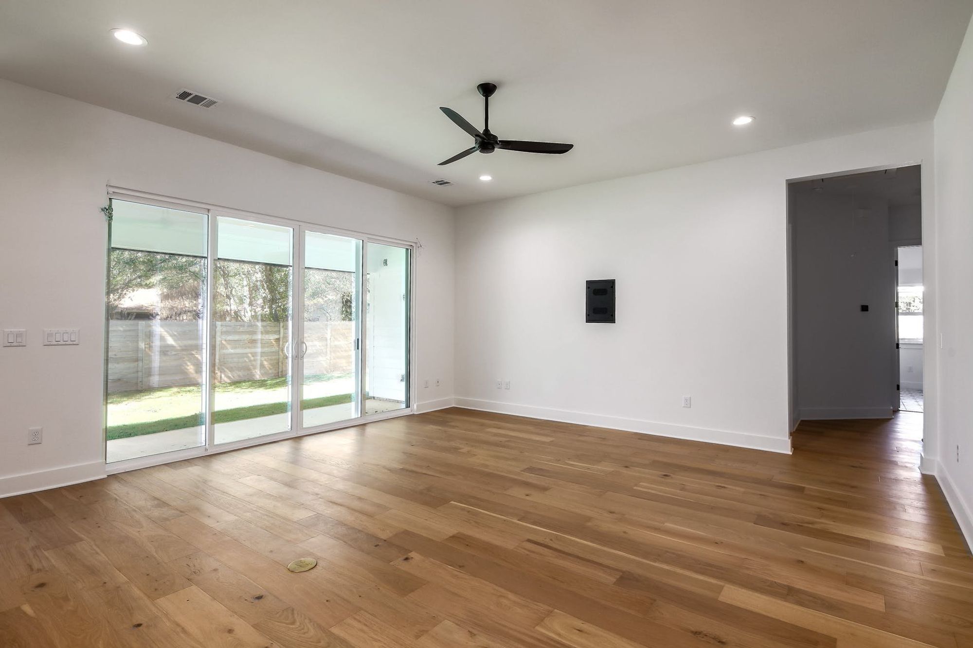 8302 Kromer Street Austin, TX 78757 - Photo 12 of 34 Unfurnished room with light wood-style flooring, a ceiling fan, and recessed lighting