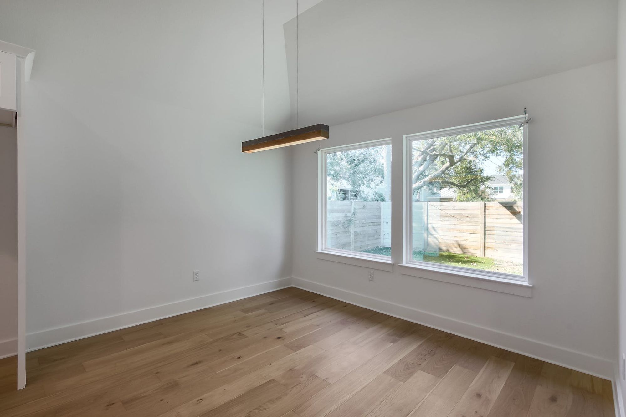 8302 Kromer Street Austin, TX 78757 - Photo 16 of 34 Unfurnished room featuring light wood-style flooring and baseboards