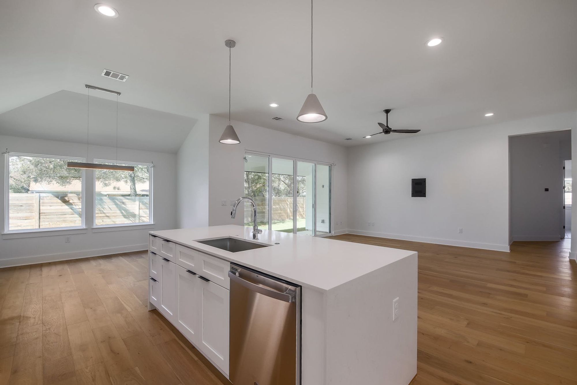 8302 Kromer Street Austin, TX 78757 - Photo 34 of 34 Kitchen featuring dishwasher, open floor plan, a kitchen island with sink, and pendant lighting