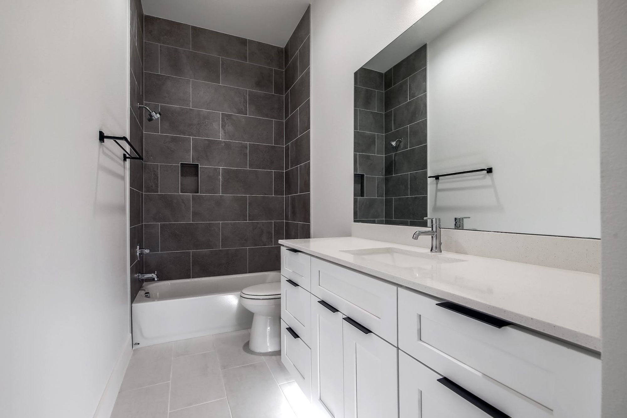 8302 Kromer Street Austin, TX 78757 - Photo 21 of 34 Full bathroom featuring vanity, shower / bath combination, and light tile patterned floors