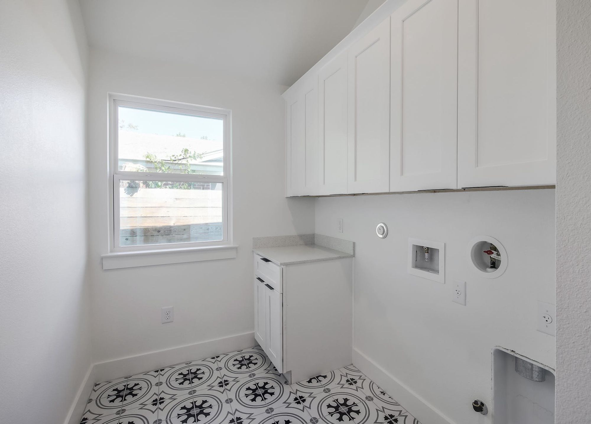 8302 Kromer Street Austin, TX 78757 - Photo 24 of 34 Laundry area featuring hookup for a gas dryer, washer hookup, light tile patterned floors, and cabinet space