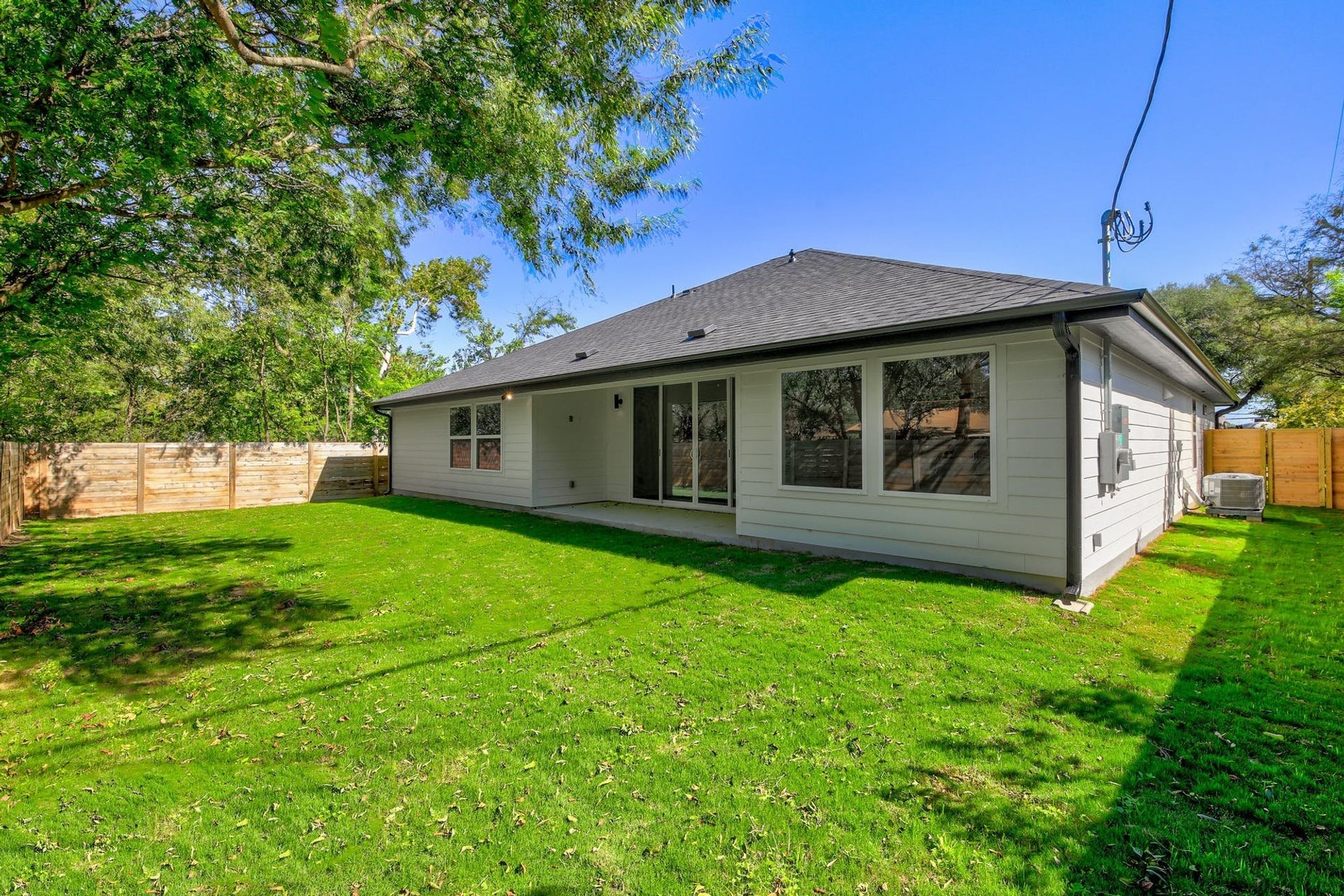 8302 Kromer Street Austin, TX 78757 - Photo 29 of 34 Back of house featuring a fenced backyard, a patio area, and roof with shingles
