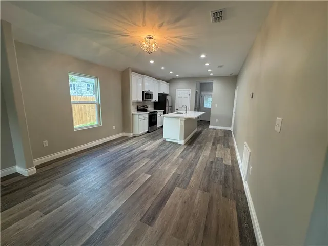 a view of kitchen with cabinets and wooden floor