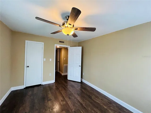 a bathroom with a granite countertop sink mirror vanity bathtub and toilet
